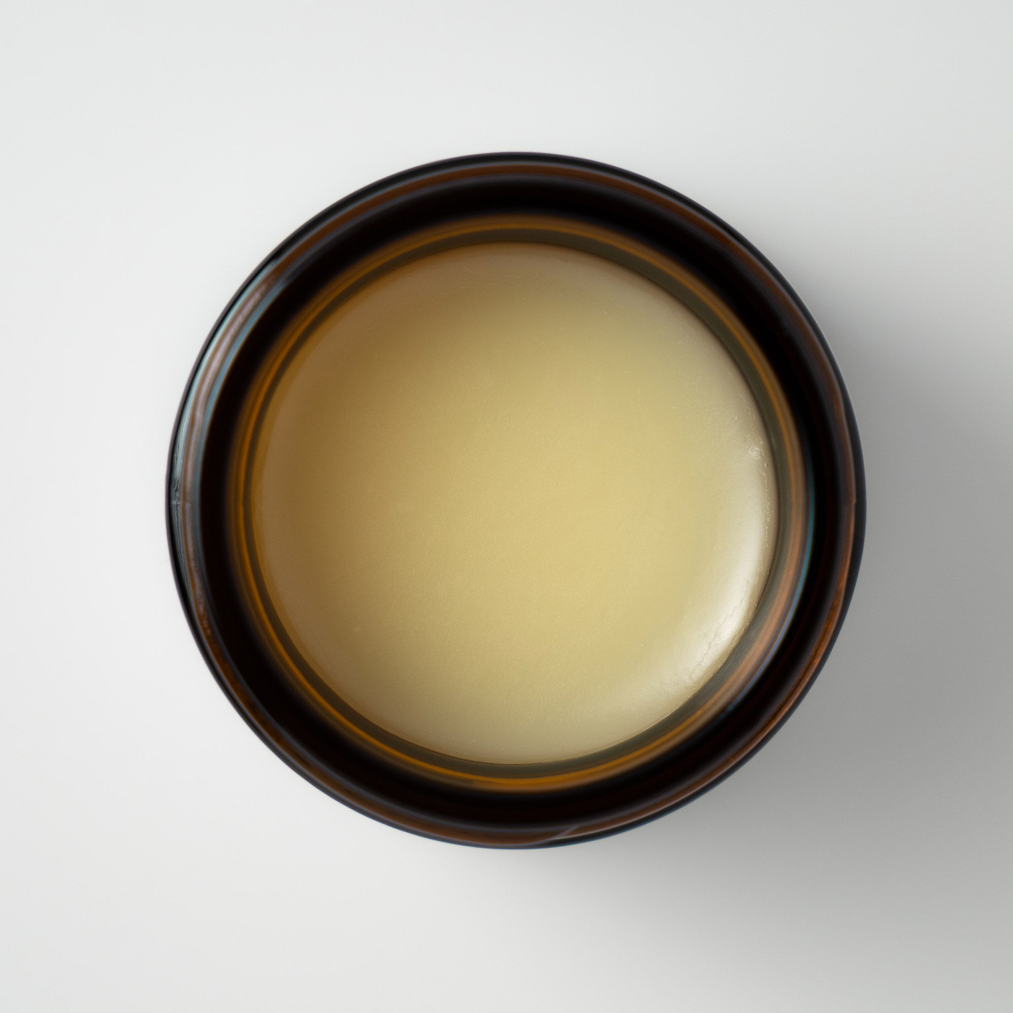 Top view of open jar of Fat & Bloom Daily Essential tallow balm.