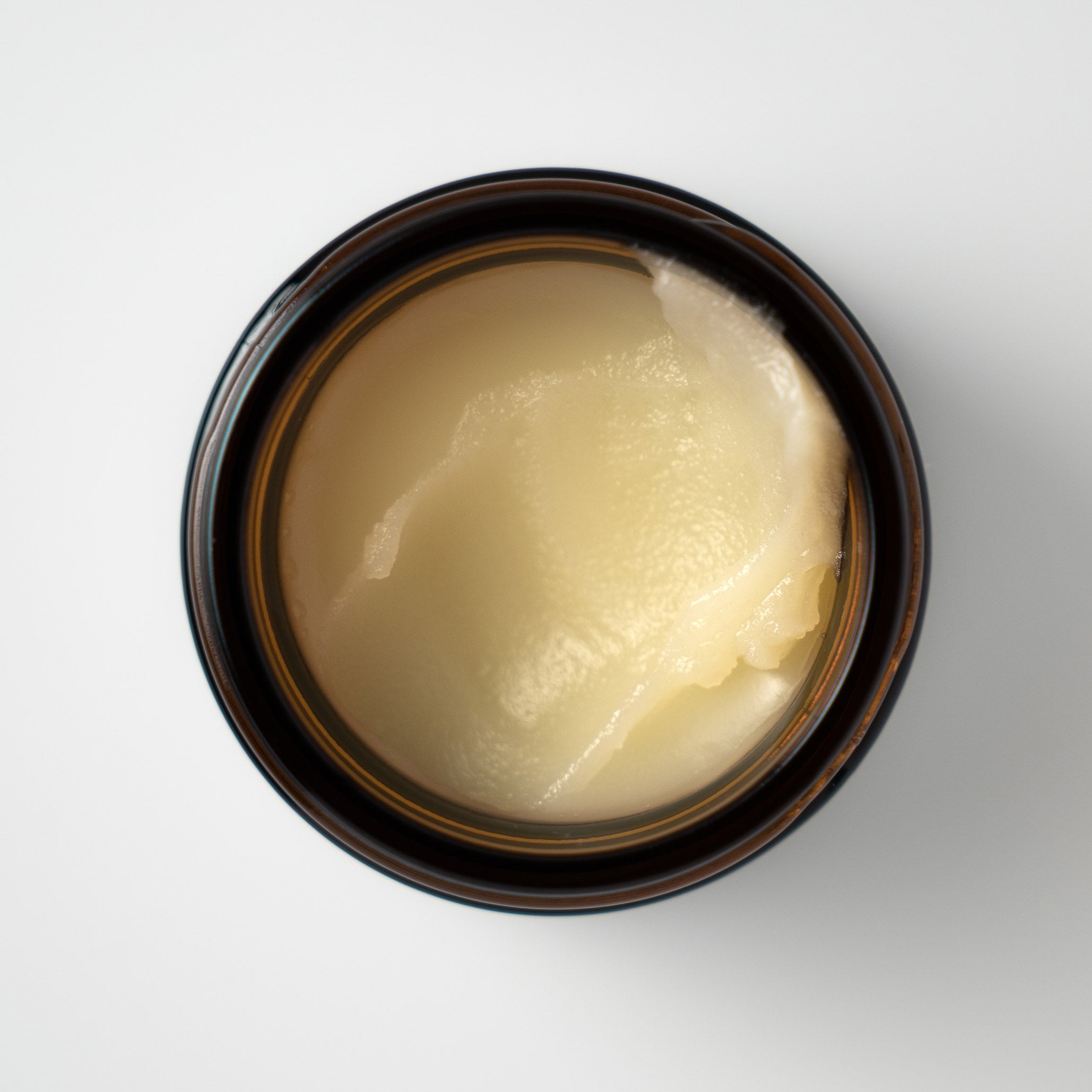 Fat & Bloom Daily Essential tallow balm scooped, top view